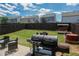 Large grill and seating area in backyard with wood shed and full privacy fence at 109 Auburn Crossing Dr, Auburn, GA 30011