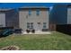 Backyard view with patio, grill, seating, and grassy area with privacy fence at 109 Auburn Crossing Dr, Auburn, GA 30011