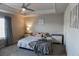 Comfortable bedroom with a ceiling fan, tray ceiling, and ample natural light from the large window at 109 Auburn Crossing Dr, Auburn, GA 30011