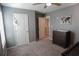 Cozy carpeted bedroom with a closet, dresser, and neutral wall paint at 109 Auburn Crossing Dr, Auburn, GA 30011