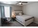 Inviting bedroom with a ceiling fan, large window, and cozy chair; perfect for relaxation at 109 Auburn Crossing Dr, Auburn, GA 30011