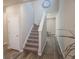 Entryway with gray walls, staircase, and wood look flooring leading into the home at 109 Auburn Crossing Dr, Auburn, GA 30011