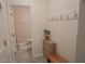 Hallway featuring a powder room and coat rack with decor at 109 Auburn Crossing Dr, Auburn, GA 30011