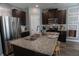 Kitchen featuring dark wood cabinets, stainless steel appliances and granite countertops at 109 Auburn Crossing Dr, Auburn, GA 30011