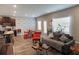 Bright living room with kitchen and dining area, showcasing hardwood floors and ample space at 109 Auburn Crossing Dr, Auburn, GA 30011