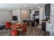 Bright living room with open layout to the kitchen and dining area, with hardwood floors at 109 Auburn Crossing Dr, Auburn, GA 30011