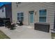 Outdoor patio area with furniture, storage box, and access door to the home at 109 Auburn Crossing Dr, Auburn, GA 30011