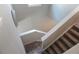 Stairway featuring carpeted steps with white risers and beige colored walls at 109 Auburn Crossing Dr, Auburn, GA 30011