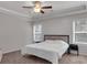 Neutral primary bedroom with carpet floor, ceiling fan, and natural light from large windows at 2099 Easterwood Ter, Decatur, GA 30032
