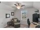 Cozy bedroom featuring a ceiling fan, ample natural light, and comfortable seating area at 2099 Easterwood Ter, Decatur, GA 30032