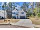 Attractive home featuring gray siding, dark shutters, a well-maintained lawn, and a driveway at 2099 Easterwood Ter, Decatur, GA 30032
