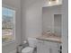 Well-lit half bathroom with granite countertop, white cabinets, and modern fixtures at 2099 Easterwood Ter, Decatur, GA 30032