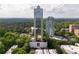 Stunning aerial view of a high-rise condo building surrounded by lush greenery and city skyline at 2828 Peachtree Nw Rd # 1501, Atlanta, GA 30305