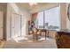Bedroom features a built-in bookcase, desk, and city views from the large window at 2828 Peachtree Nw Rd # 1501, Atlanta, GA 30305