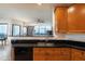 Bright kitchen featuring granite countertops, wood cabinets, and a large window offering city views at 2828 Peachtree Nw Rd # 1501, Atlanta, GA 30305