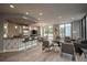 Open-concept living room with modern finishes, a breakfast bar, and large windows for ample natural light at 2828 Peachtree Nw Rd # 1501, Atlanta, GA 30305