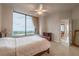 Bright main bedroom with a large window, neutral decor, and a glimpse into the dining area at 2828 Peachtree Nw Rd # 1501, Atlanta, GA 30305