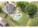 Stunning aerial view of a home with a freeform pool, spa, and lush green lawn perfect for outdoor living at 440 Scott Farm Dr, Powder Springs, GA 30127