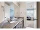 Bathroom featuring double sinks, a granite countertop, and a view of a bedroom at 440 Scott Farm Dr, Powder Springs, GA 30127