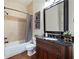 Bathroom featuring a tub-shower combo, granite vanity, and decorative accents at 440 Scott Farm Dr, Powder Springs, GA 30127