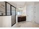 Modern bathroom with a tiled shower, glass door, and a dark wood vanity at 440 Scott Farm Dr, Powder Springs, GA 30127