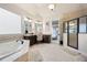 Bathroom suite featuring double vanities, soaking tub, separate shower, and elegant finishes for a spa-like experience at 440 Scott Farm Dr, Powder Springs, GA 30127