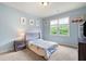 Bright bedroom with light blue walls and a large window overlooking a lush backyard at 440 Scott Farm Dr, Powder Springs, GA 30127