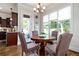 Cozy breakfast nook featuring a round table, wooden floors, and bright windows overlooking the backyard at 440 Scott Farm Dr, Powder Springs, GA 30127