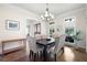 Spacious dining room with large windows, stylish furniture, and elegant chandelier at 440 Scott Farm Dr, Powder Springs, GA 30127