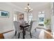 Bright dining area showcasing hardwood floors and seating for four beneath a decorative chandelier at 440 Scott Farm Dr, Powder Springs, GA 30127