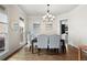 Bright dining room with modern chandelier, neutral decor, and ample natural light at 440 Scott Farm Dr, Powder Springs, GA 30127
