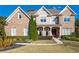 Beautiful brick two-story home with a well-manicured lawn and covered front porch at 440 Scott Farm Dr, Powder Springs, GA 30127