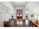 Inviting foyer with hardwood floors, elegant lighting, and a view to living spaces at 440 Scott Farm Dr, Powder Springs, GA 30127