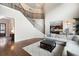 Elegant foyer with a staircase, hardwood floors, and open access to the kitchen and dining area at 440 Scott Farm Dr, Powder Springs, GA 30127