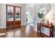 Welcoming foyer with hardwood floors, stylish console table, mirror, and glass-paneled doors at 440 Scott Farm Dr, Powder Springs, GA 30127