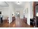 Long hallway with hardwood floors, white trim, and views of other living spaces at 440 Scott Farm Dr, Powder Springs, GA 30127