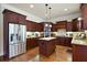 Gourmet kitchen featuring rich wood cabinetry, stainless steel appliances, and a center island with granite countertops at 440 Scott Farm Dr, Powder Springs, GA 30127
