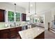 Well-appointed kitchen with stainless steel appliances and granite counters, seamlessly connecting to the living area at 440 Scott Farm Dr, Powder Springs, GA 30127