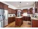 Spacious kitchen with granite countertops, custom cabinets, stainless steel appliances, and a central island at 440 Scott Farm Dr, Powder Springs, GA 30127