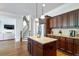 Gourmet kitchen with a large island, stainless steel fridge, and dark wood cabinetry at 440 Scott Farm Dr, Powder Springs, GA 30127