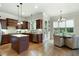 Open concept kitchen with dark cabinets, granite countertops, and a breakfast nook at 440 Scott Farm Dr, Powder Springs, GA 30127
