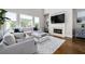 Bright living room with a fireplace, large windows, and a comfortable white sectional sofa at 440 Scott Farm Dr, Powder Springs, GA 30127