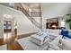 Spacious living area showcasing hardwood floors, a staircase, and an open layout to the kitchen at 440 Scott Farm Dr, Powder Springs, GA 30127