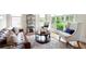 Well-lit living room with a leather couch, accent chairs, patterned rug, and natural light from the windows at 440 Scott Farm Dr, Powder Springs, GA 30127
