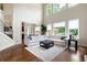 Spacious living room featuring soaring ceilings, oversized windows, and an open layout with dark, glossy hardwood floors at 440 Scott Farm Dr, Powder Springs, GA 30127