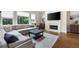 Comfortable living room with a fireplace, large sofa, and hardwood floors at 440 Scott Farm Dr, Powder Springs, GA 30127