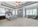 Serene main bedroom suite featuring a tray ceiling, plush carpeting, and sitting area with outdoor access at 440 Scott Farm Dr, Powder Springs, GA 30127