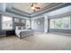 Tranquil main bedroom suite featuring tray ceilings, plush carpeting, and plenty of natural light at 440 Scott Farm Dr, Powder Springs, GA 30127