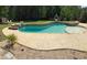 Beautiful backyard pool with a sandy beach entry, spa, and mature trees for privacy at 440 Scott Farm Dr, Powder Springs, GA 30127