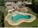 Stunning backyard oasis with custom pool, spa, stone patio, pergola, and fire pit at 440 Scott Farm Dr, Powder Springs, GA 30127